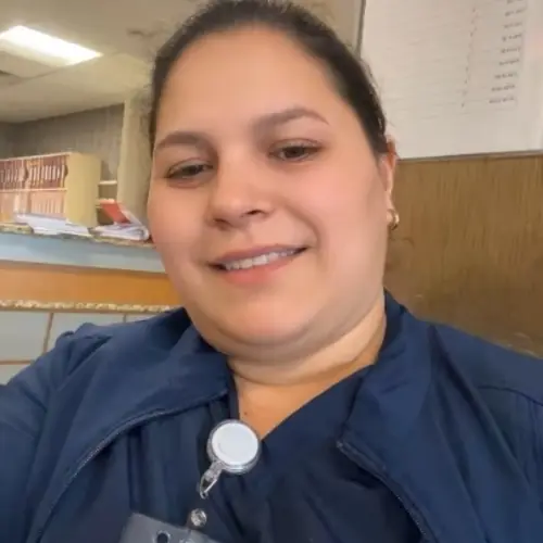 Monica Garcia wearing CNA scrubs at Optima Castle Hill